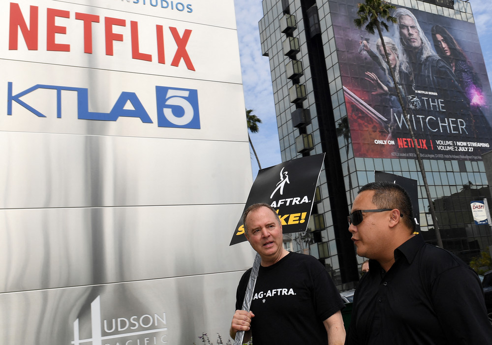 Rep. Adam Schiff (D-Calif.) joins members of the Writers Guild of America and the Screen Actors Guild as they walk the picket line outside of Netflix in Los Angeles on July 17. 