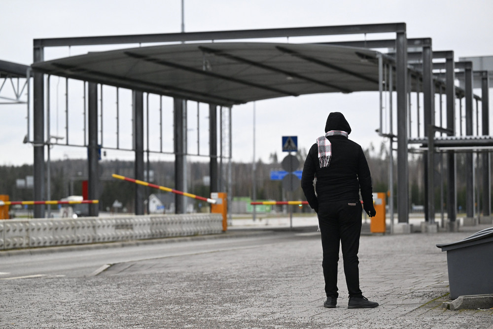 A man stands at a border checkpoint between Russia and Finland on Nov. 15, 2023.