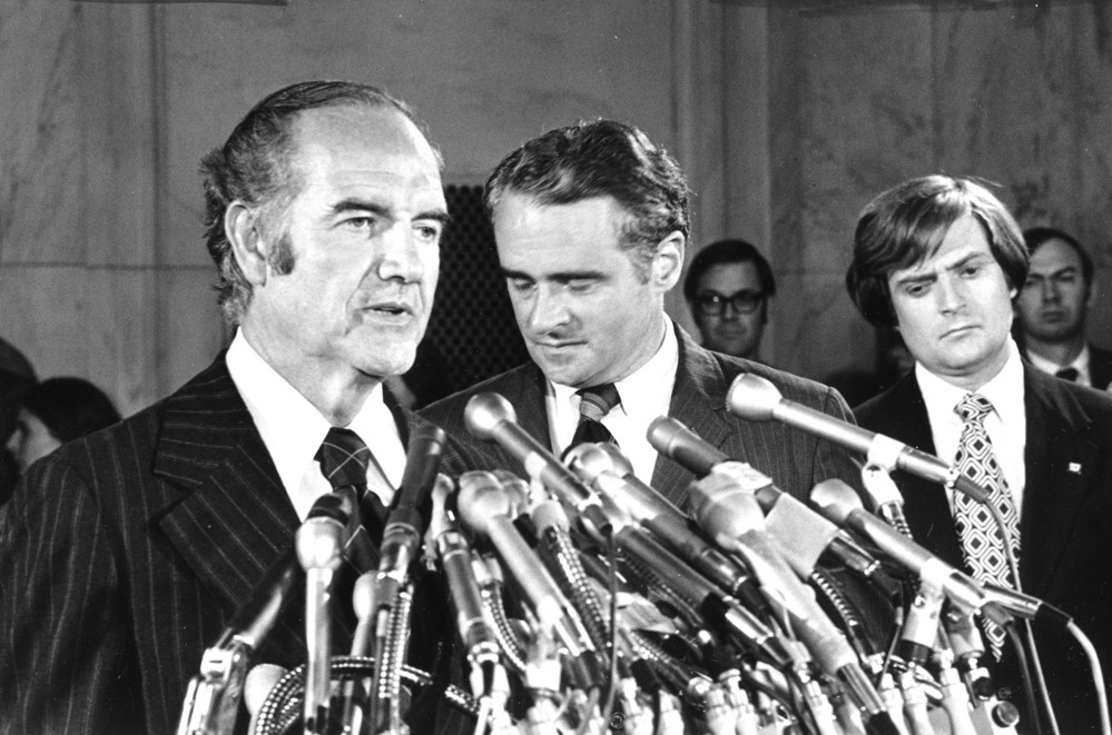 On this date in 1972: Sen. Thomas Eagleton, center rear, has his head down as he listens to Democratic presidential hopeful Sen. George McGovern's announcement that Eagleton is stepping aside as vice-presidential running mate at a Washington news conference. Eagleton was named McGovern's running mate 18 days earlier, but Eagleton's unreported history of depression — which had led to hospitalizations — led to the McGovern campaign's decision to drop
 him from the ticket. 