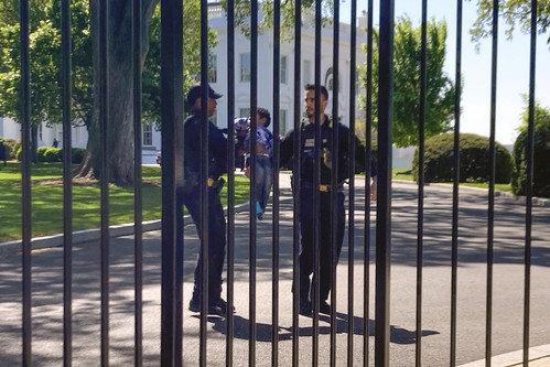 U.S. Secret Service uniformed division police officers carry a young child who crawled through the White House fence.