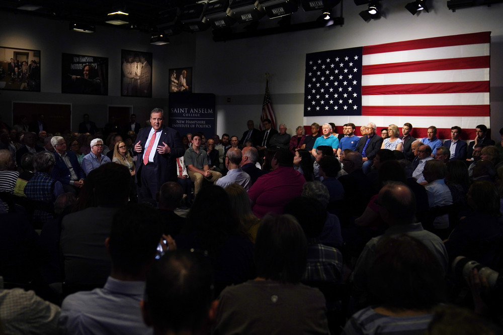 Republican Presidential candidate Chris Christie speaks with voters during a gathering in Manchester, N.H.