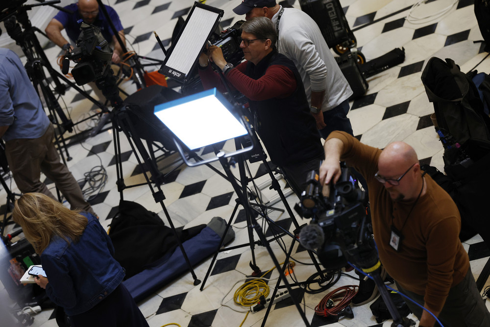 Journalists set up equipment for TV networks in Statuary Hall in the U.S. Capitol in preparation for President Joe Biden's State of the Union address. 