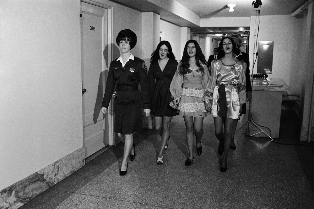 On this date in 1970: Holding hands and singing, three female defendants in the Sharon Tate murder case walk down a Los Angeles Hall of Justice corridor for a pre-trial hearing. The women from left are, Susan Atkins, Patricia Krenwinkel, and Leslie Van Houten. All three were sentenced to death, which was then commuted to life imprisonment. Van Houten was granted a retrial and was released on parole in 2023, while Atkins died in prison and Krenwinkel remains
 in prison.