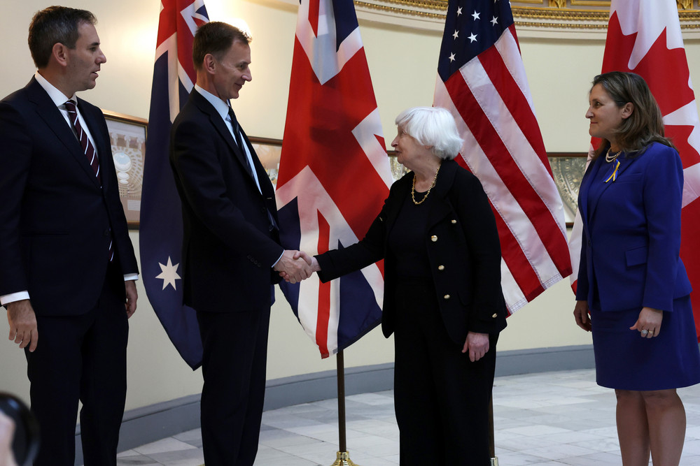 Secretary of the Treasury Janet Yellen shakes hands with Chancellor of the Exchequer Jeremy Hunt of the United Kingdom as Treasurer Jim Chalmers of Australia (left) and Deputy Prime Minister and Finance Minister Chrystia Freeland of Canada (right) look on in Washington. 