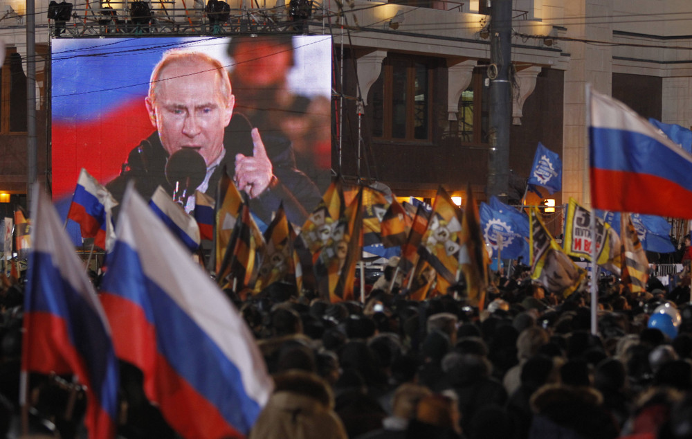 On this date in 2012: Russia holds national elections, with Vladimir Putin winning a third term, though the opposition and independent observers said the result was marred by widespread violations. Pictured are supporters of Putin rallying outside the Kremlin. 