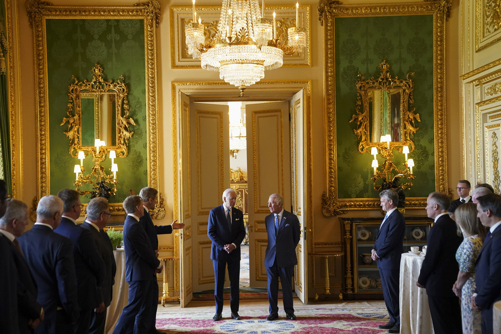 U.S. special climate envoy John Kerry speaks to President Joe Biden and Britain's King Charles III during a climate meeting at Windsor Castle today.