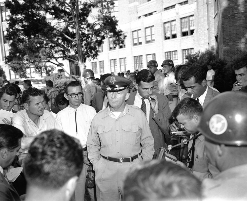 On this date in 1957: A school integration battle in the South ramps up, as Major-General Sherman Clinger of the Arkansas National Guard speaks in front of Little Rock's Central High School. Clinger told the press assembled that the National Guard had been told by Gov. Orval Faubus to keep black students from entering the school. He also said that he was in complete command and had the authority to arrest and confine any member of the press who appeared to be inciting a
 riot either by questions or actions. The event became known as the Little Rock Crisis.