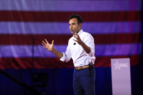 Vivek Ramaswamy speaking in front of an American flag.