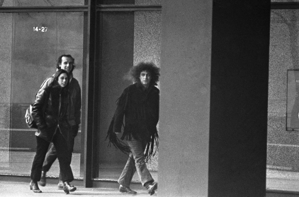 On this date in 1970: Defendant Abbie Hoffman, wearing a fringed leather jacket, strides to entrance of Federal Building in Chicago for the 100th day of the trial of he and six others charged with conspiracy to riot at time of 1968 Democratic National Convention.