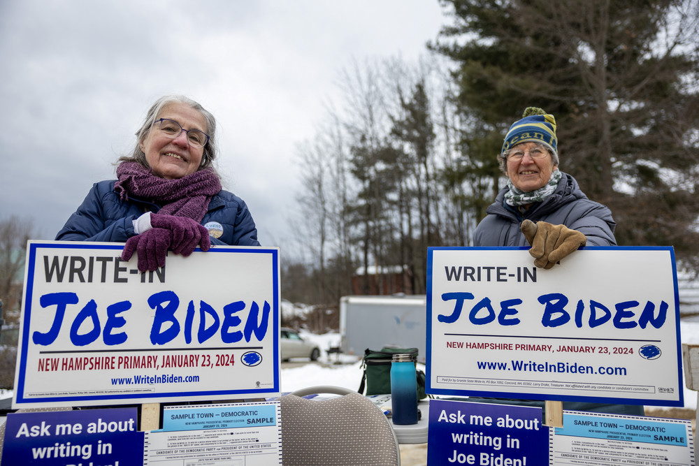 Supporters of President Joe Biden greet voters in Loudon, New Hampshire.