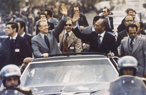 On this date in 1979: U.S. President Jimmy Carter rides in a motorcade with Egypt's President Anwar Sadat in Cairo.
