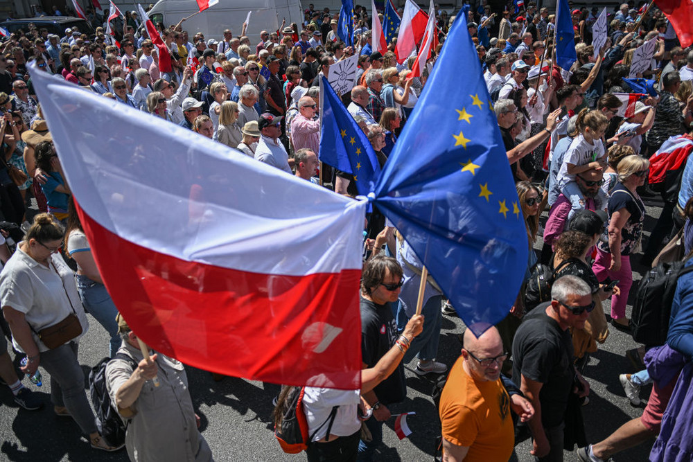 Supporters of opposition parties hold European Union and Polish flags and banners during the Freedom march organized by the main opposition party in Warsaw, Poland, June 4. 