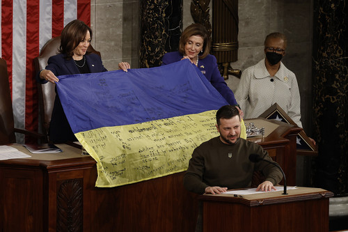 Speaker of the House Nancy Pelosi and Vice President Kamala Harris hold a Ukrainian flag signed by members of Ukraine's military given to them by President of Ukraine Volodymyr Zelenskyy.