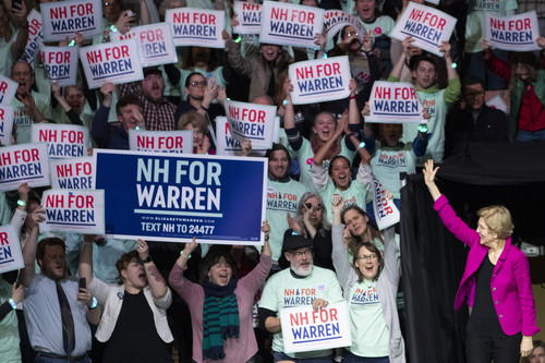 Democratic presidential candidate Sen. Elizabeth Warren, D-Mass., waves at her supporters as she arrives on stage during the McIntyre-Shaheen 100 Club Dinner, Saturday, Feb. 8, 2020, in Manchester, N.H. (AP Photo/Mary Altaffer)