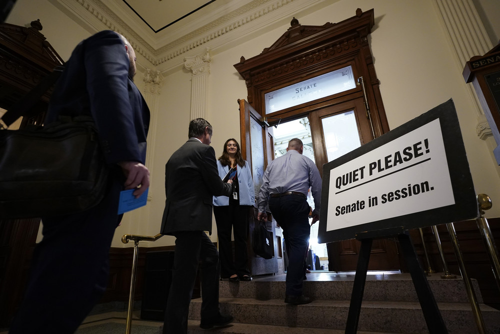 Members of the public enter the Senate Chamber at the Texas Capitol for day three of the impeachment trial for Texas Attorney General Ken Paxton today. A sign reads "QUIET PLEASE! Senate in session."