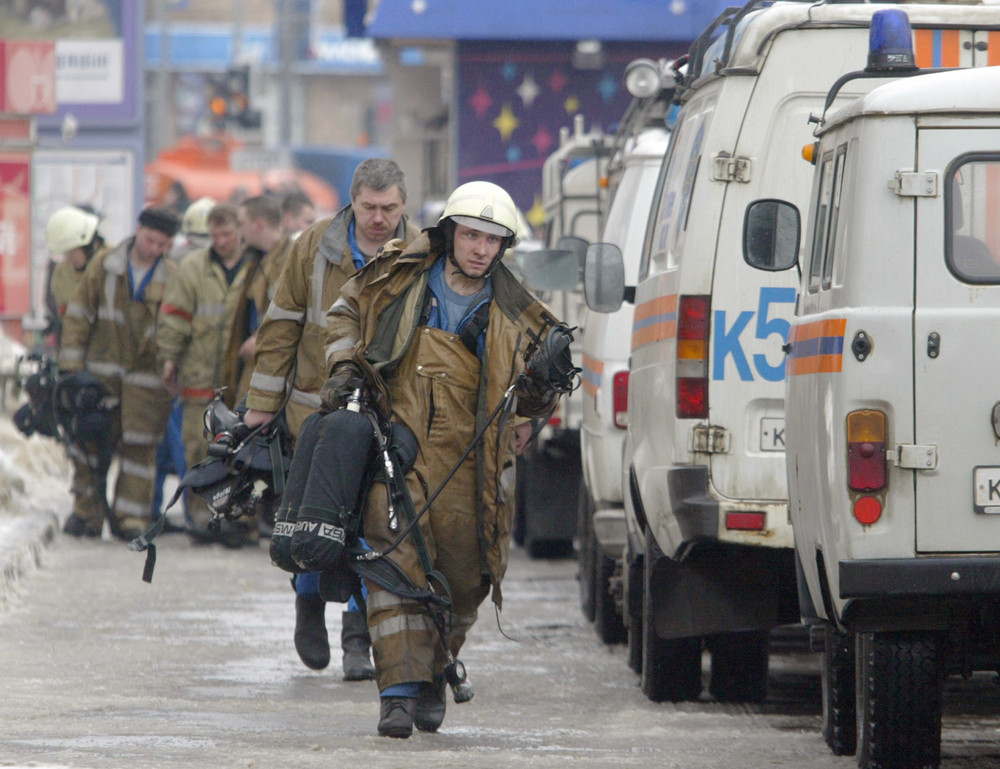 On this date in 2004: A suicide bomber kills 41 people and injures around 250 during rush hour in a Moscow metro station. A Chechen terrorist group ultimately claimed responsibility for the bombing. Pictured, Ministry of Emergency Situations rescue workers carry oxygen containers to victims. 