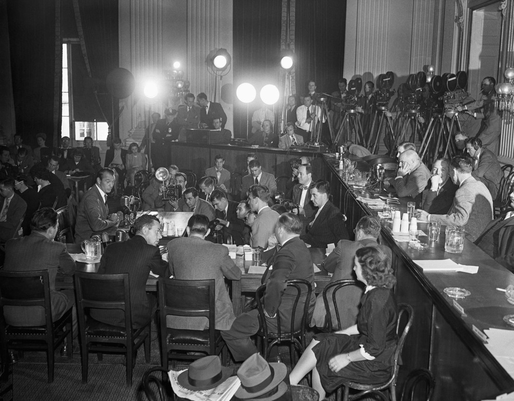 On this date in 1947: Actor Gary Cooper (far left at microphone) testifies at a hearing in Washington of the House Un-American Activities Committee. Seated (right) at committee table are Reps. Richard B. Vail (R-Ill.); J. Parnell Thomas (R-N.J.), chairman; John McDowell (R-Pa.) and John S. Wood (D-Ga.), all committee members. 