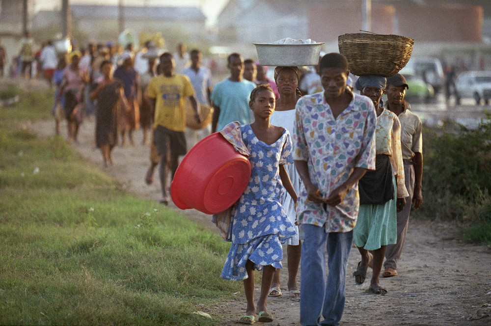 On this date in 1993: Residents of the Port-au-Prince neighborhood Cité Soleil, make their way to the downtown market. Normally they are picked up by buses, however, with a week-long oil embargo in effect, the only way to get there was on foot. 