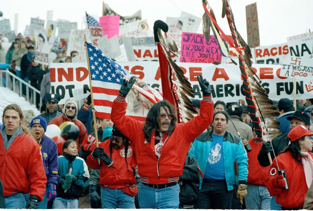 On this date in 1992: Native Americans and supporters protest outside the Metrodome in Minneapolis before the start of the Super Bowl XXVI between Washington and Buffalo. Native Americans groups opposed Washington's team name, a pejorative slang term. The name was changed in 2020. 