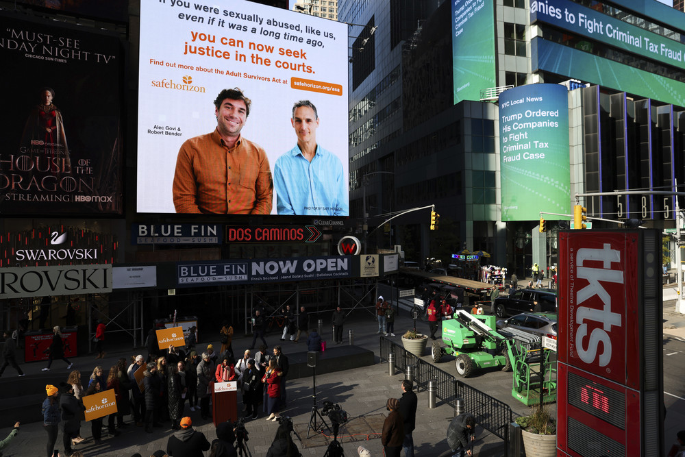 A Safe Horizon PSA about the Adult Survivors Act plays in Times Square during a press conference on the new law, Friday, Nov. 18, 2022, in New York.