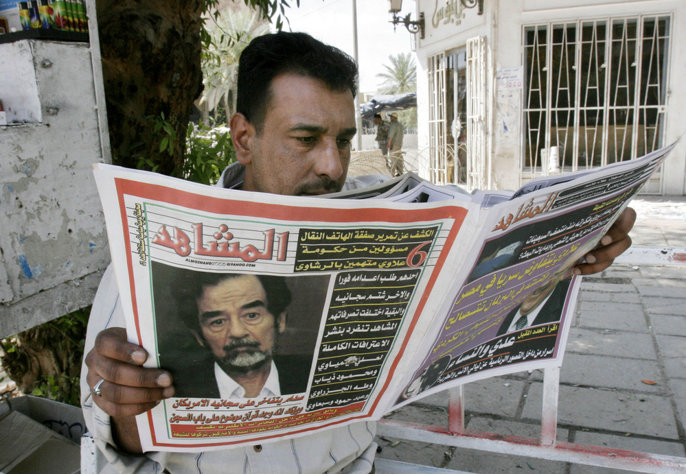 On this date in 2006: An Iraqi man reads a newspaper featuring a picture of Saddam Hussein on the front page in Baghdad. The Iraq tribunal announced new criminal charges against Saddam Hussein and six others for alleged genocide and crimes against humanity in 1980s crackdown against the Kurds. 