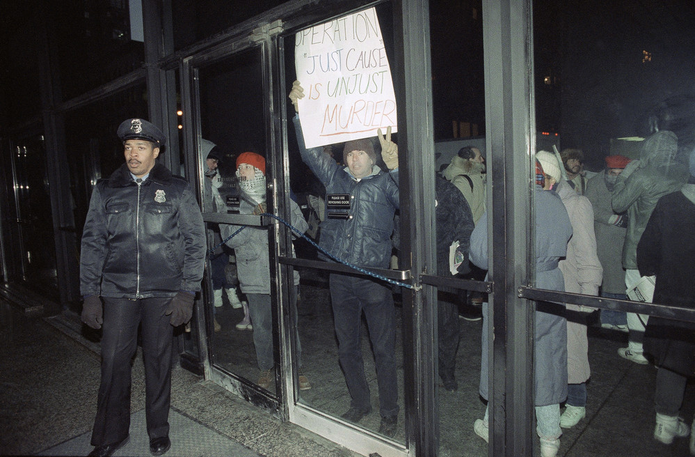 On this date in 1989: Demonstrators, protesting the United States military action in Panama, congregate outside the Federal building in Chicago. The protesters, made up of Central American human rights groups, were allowed to march inside the building for several minutes, then were forcibly removed when they refused to leave on their own. 
