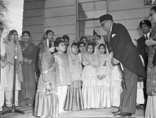 On this day in 1956: Pakistan's High Commissioner in London, Mohammed Kramullah, is surrounded by children in national dress during the celebrations marking the inauguration of the Islamic Republic of Pakistan.