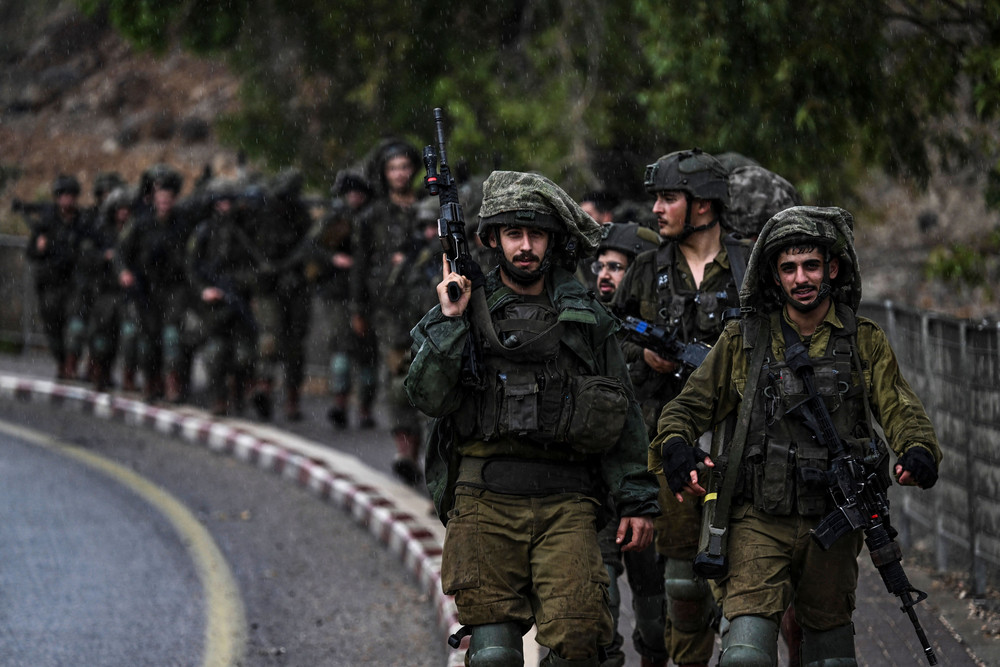 Israeli army soldiers patrol an undisclosed area in northern Israel bordering Lebanon on October 15, 2023. 