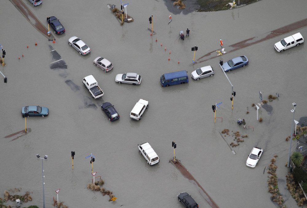 On this date in 2011: Cars are abandoned on a flooded street after a strong earthquake in suburban Christchurch, New Zealand. The powerful earthquake collapsed buildings at the height of a busy workday killing 185 people and injuring thousands in one of the country's worst natural disasters. 