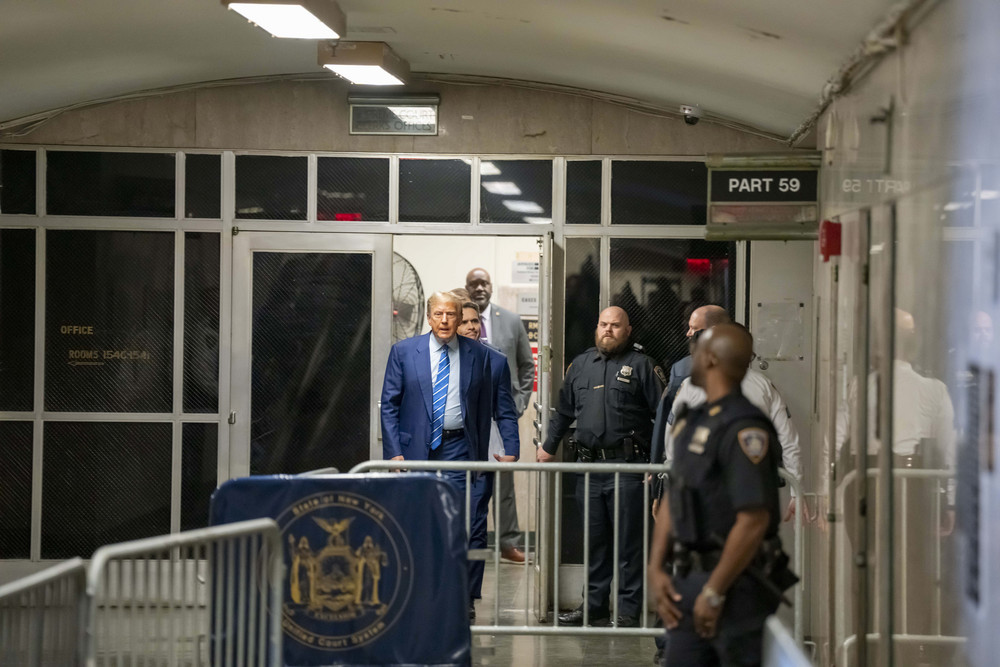 Former President Donald Trump walks outside during the second day of his trial at a Manhattan criminal court.