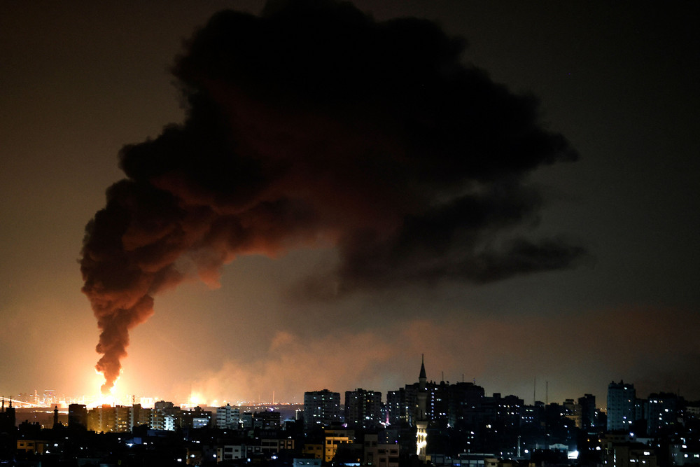 A huge column of smoke seen from Gaza city billows from an oil facility in the southern Israeli city of Ashkelon on May 11, 2021, after rockets were fired by Hamas from the Gaza Strip towards Israel. 