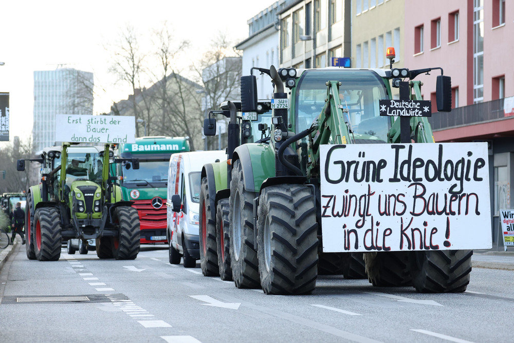 Farmers use their tractors to block access on roads on the first day of a week of protests today in Bonn, Germany.