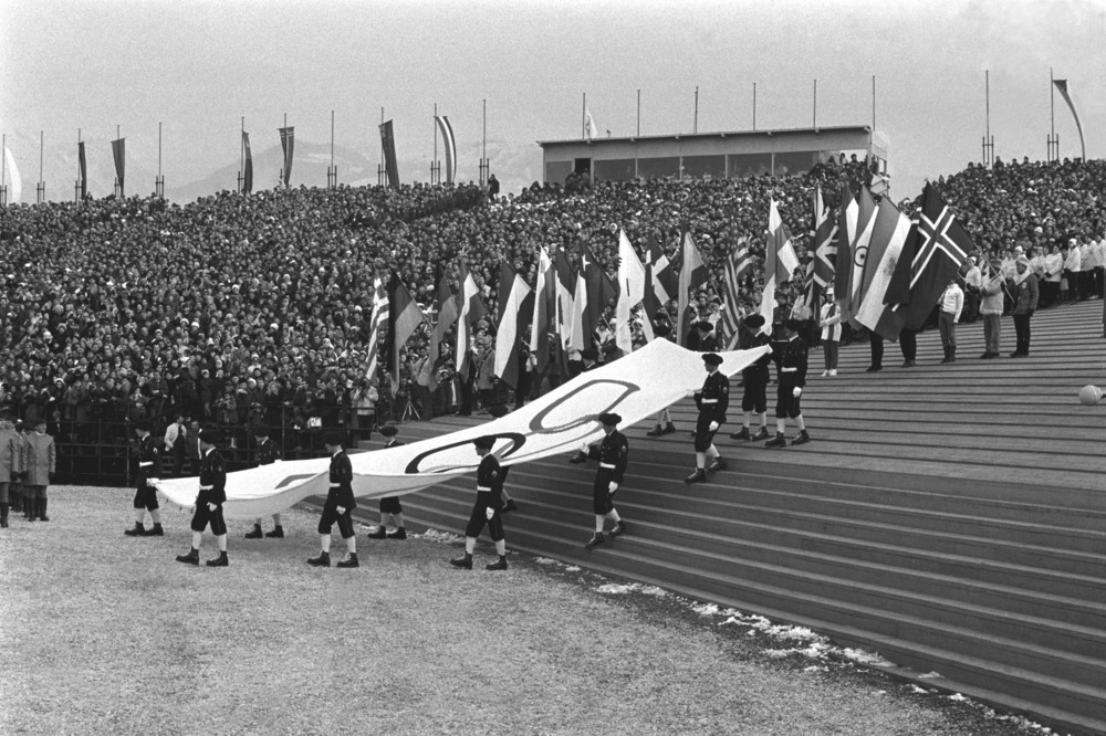 On this date in 1968: The Olympic Flag is carried by French Alpine troops during a procession at the opening ceremony of the 1968 Winter Olympics in Grenoble, France. 