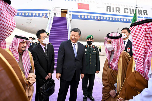 Chinese President Xi Jinping, center, is greeted by Prince Faisal bin Bandar bin Abdulaziz, Governor of Riyadh, after his arrival in Riyadh, Saudi Arabia today.
