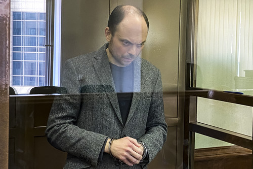 Russian opposition activist Vladimir Kara-Murza stands in a glass cage in a courtroom at the Moscow City Court today, where he was sentenced to 25 years in prison.