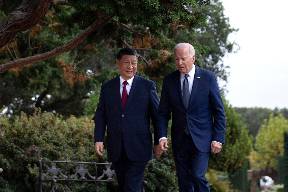 President Joe Biden and Chinese President Xi Jinping walk together.