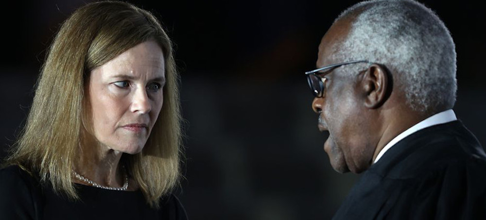 Judge Amy Coney Barrett talks with Supreme Court Associate Justice Clarence Thomas. (photo: Tasos Katopodis/Getty Images)