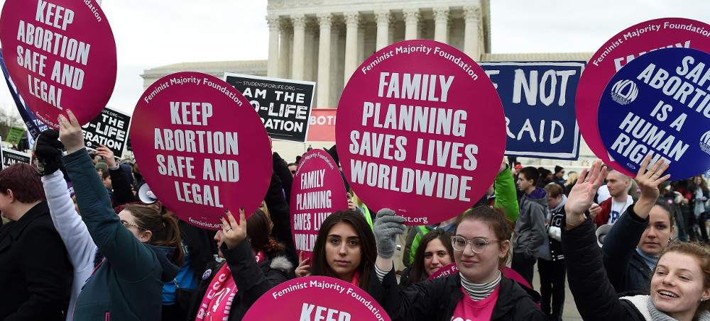 An abortion rights activist holds placards outside of the US Supreme Court. (photo: Mandel Ngan/Getty)