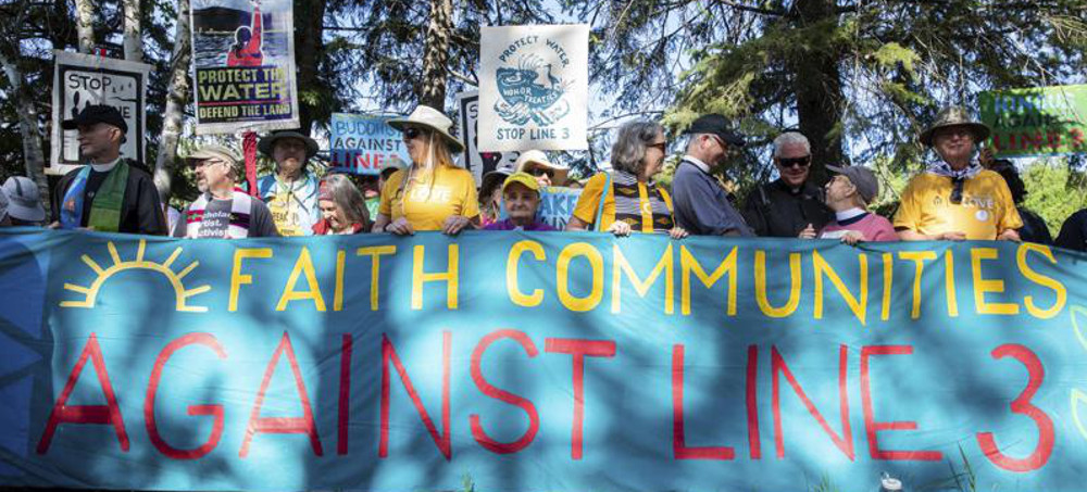 Faith leaders gather for an interfaith prayer gathering before a day of protest action against the Enbridge Line 3 oil pipeline at LaSalle Lake State Recreation Area on Monday, June 7, 2021. (photo: Evan Frost/AP)