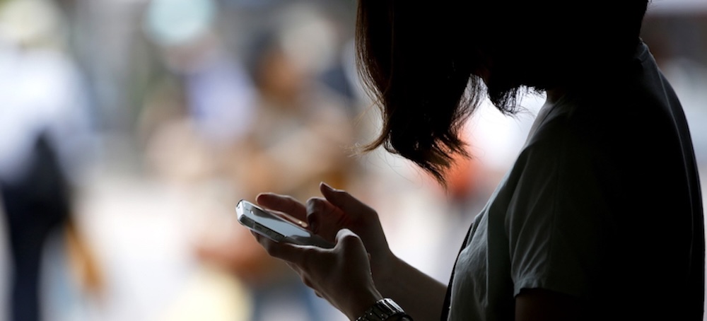 A woman uses her phone. (photo: Getty Images)