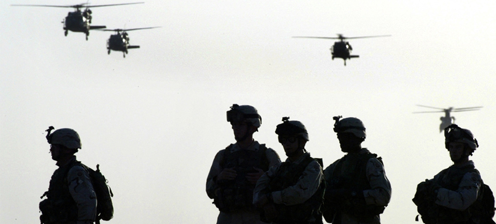 American soldiers wait to board helicopters at Kandahar airbase ahead of an operation in Afghanistan on 19 May, 2003. (photo: AFP)