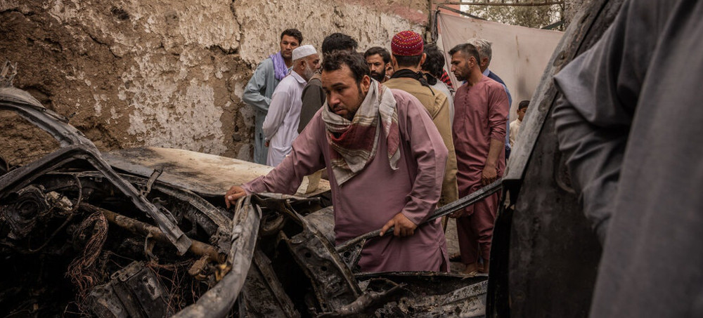 A relative examined the damage after a U.S. drone strike in Kabul last month. American officials now acknowledge that the strike was a tragic case of mistaken identity. (photo: Jim Huylebroek/The New York Times)