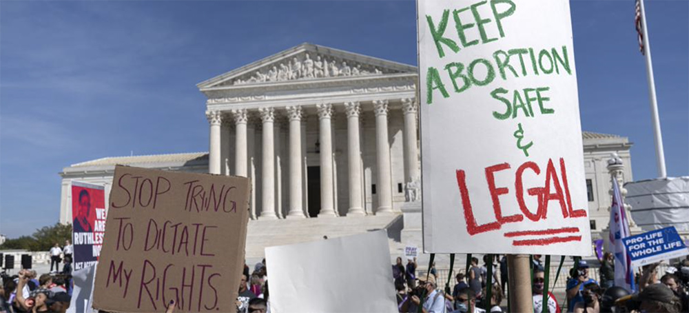 Demonstrators march outside of the the U.S. Supreme Court during the Women's March in Washington, Saturday, Oct. 2, 2021. (photo: Jose Luis Magana/AP)