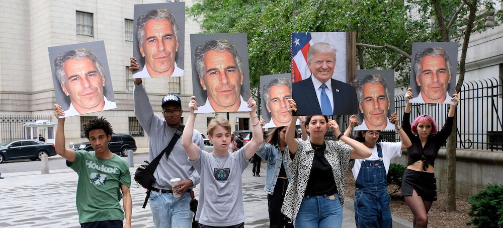 A group of protesters holds pictures of Jeffrey Epstein and Donald Trump outside the federal court in downtown Manhattan on July 8, 2019, where Jeffrey Epstein was being charged. (photo: Luiz C. Ribeiro/NY Daily News)