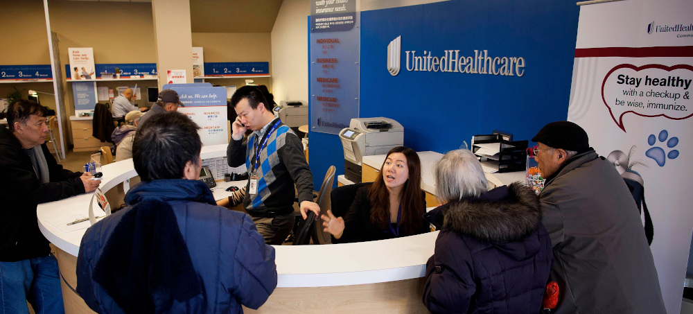 Customers get information from a reception desk at a a UnitedHealthcare store in the Queens borough of New York. (photo: Getty)