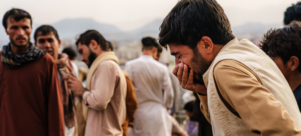 A man weeps during a mass funeral for the 10 members of a family killed in a U.S. drone strike, in Kabul, Afghanistan, on Aug. 30, 2021. (photo: Marcus Yam/Getty)