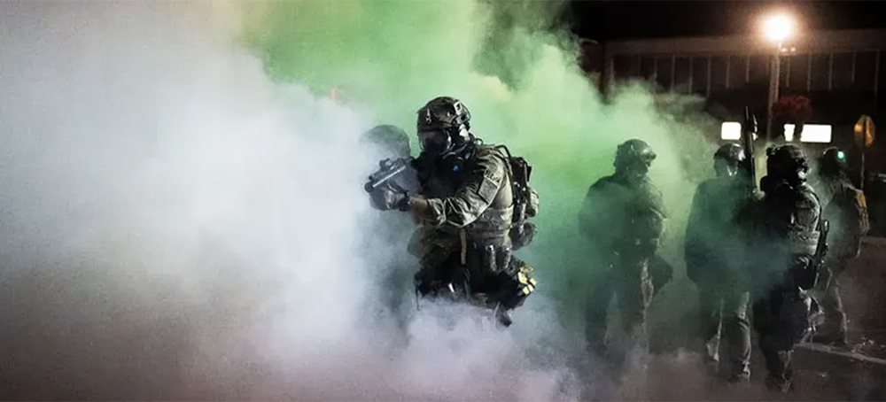 Federal officers walk through tear gas during a dispersal of about 300 protesters in front of the Immigration and Customs Enforcement (ICE) detention building on August 26, 2020 in Portland, Oregon. Protests continued for the 91st night in Portland as activists called for solidarity with rallies in Kenosha, Wisconsin. (Nathan Howard/Getty Images)