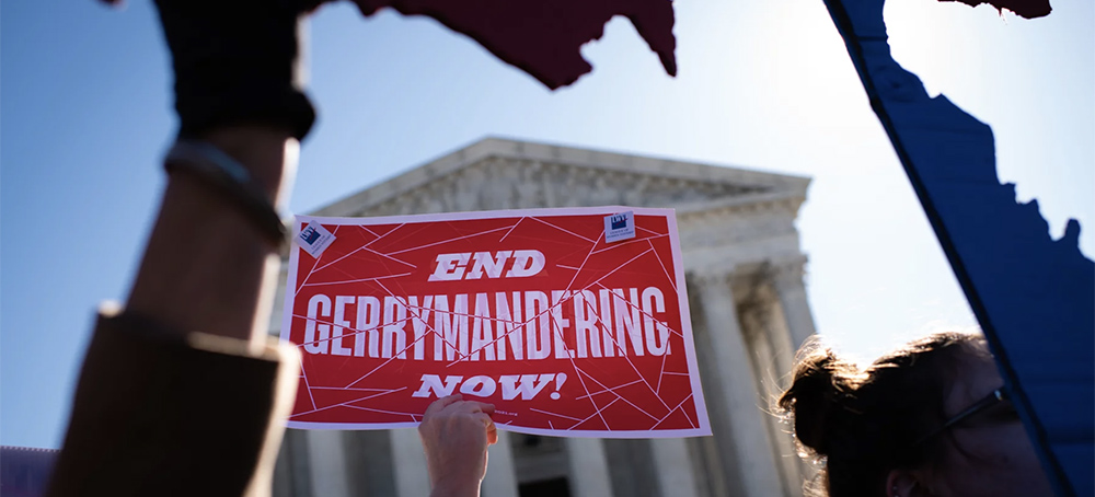 An activist holds a sign outside the U.S. Supreme Court in 2019. (photo: Sarah L. Voisin/WP/Getty Images)