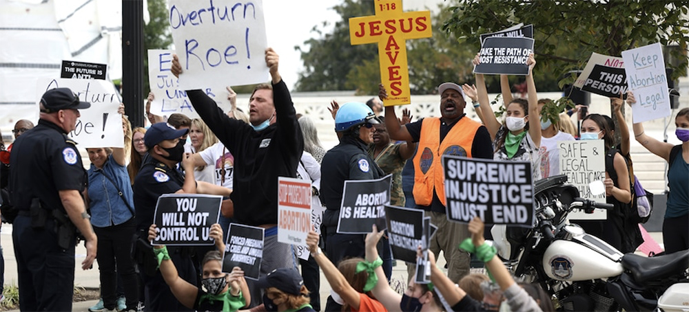 Abortion rights and antiabortion activists protest outside the Supreme Court on Oct. 4 in D.C. (photo: Kevin Dietsch/Getty Images)
