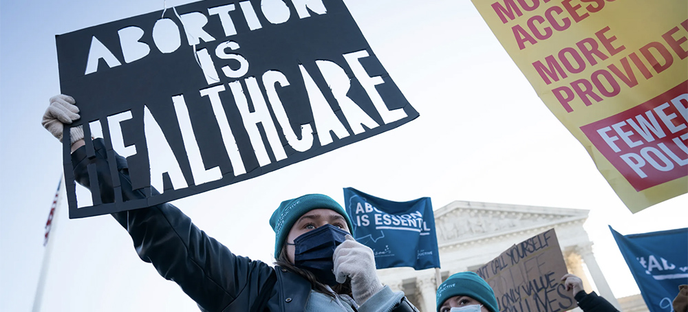 Demonstrators rally outside the Supreme Court ahead of arguments in Dobbs v. Jackson Women's Health Organization, challenging a Mississippi abortion law that would ban elective abortions after 15 weeks. (photo: Jack Gruber/USA Today)